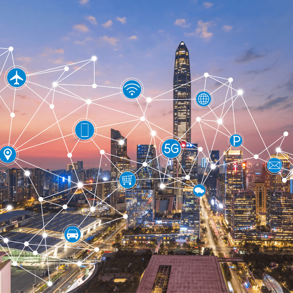 A city skyline at dusk overlaid with a network of connected nodes and icons for flights, wifi, mobile, 5G, parking, shopping, cars and mail