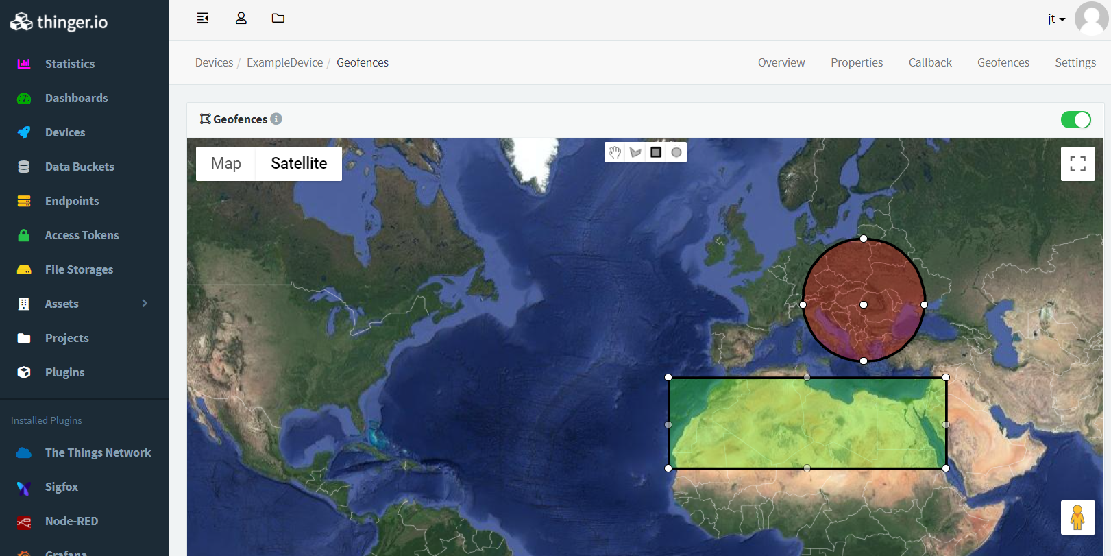 The Geofences tab of a device in the Thinger.io console: a satellite map with a circular area over central Europe and a rectangular area over North Africa, and drawing tools at the top