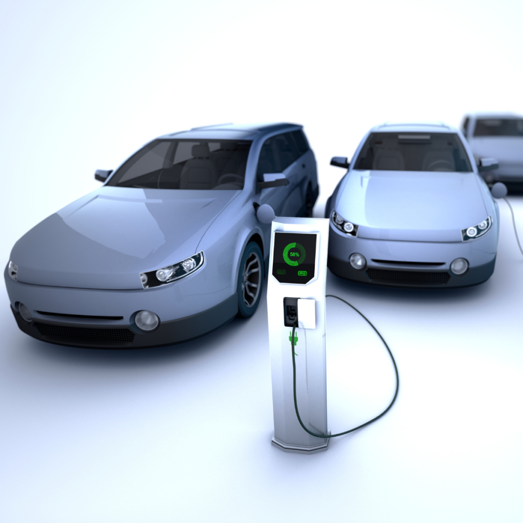 Three electric cars parked in a row beside a charging station, one of them plugged in